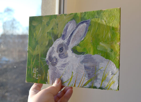 One-of-a-kind acrylic painting "White bunny portrait" by Lada Kholosho (2025). Charming and vibrant artwork featuring a rabbit in lush green foliage. Perfect for wildlife art lovers and collectors. Ships worldwide